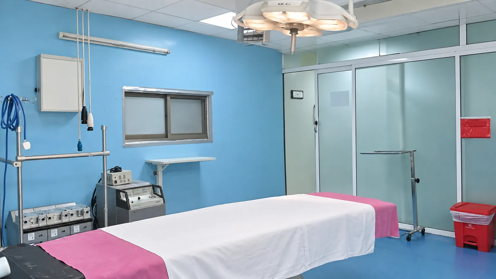 Cardiac theatre operating table and surgical lighting, viewed towards the entrance